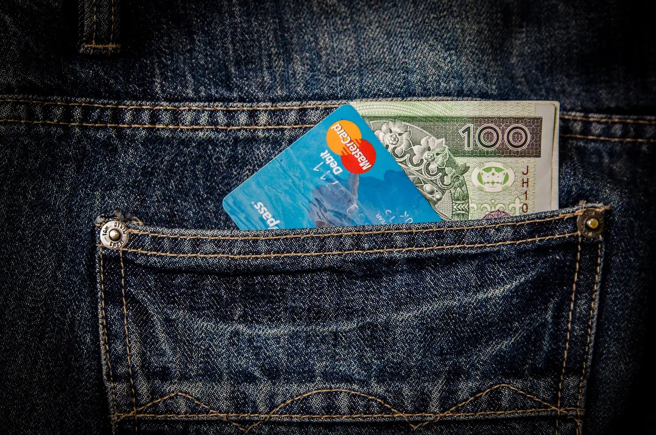A payment card on a dark reflective surface