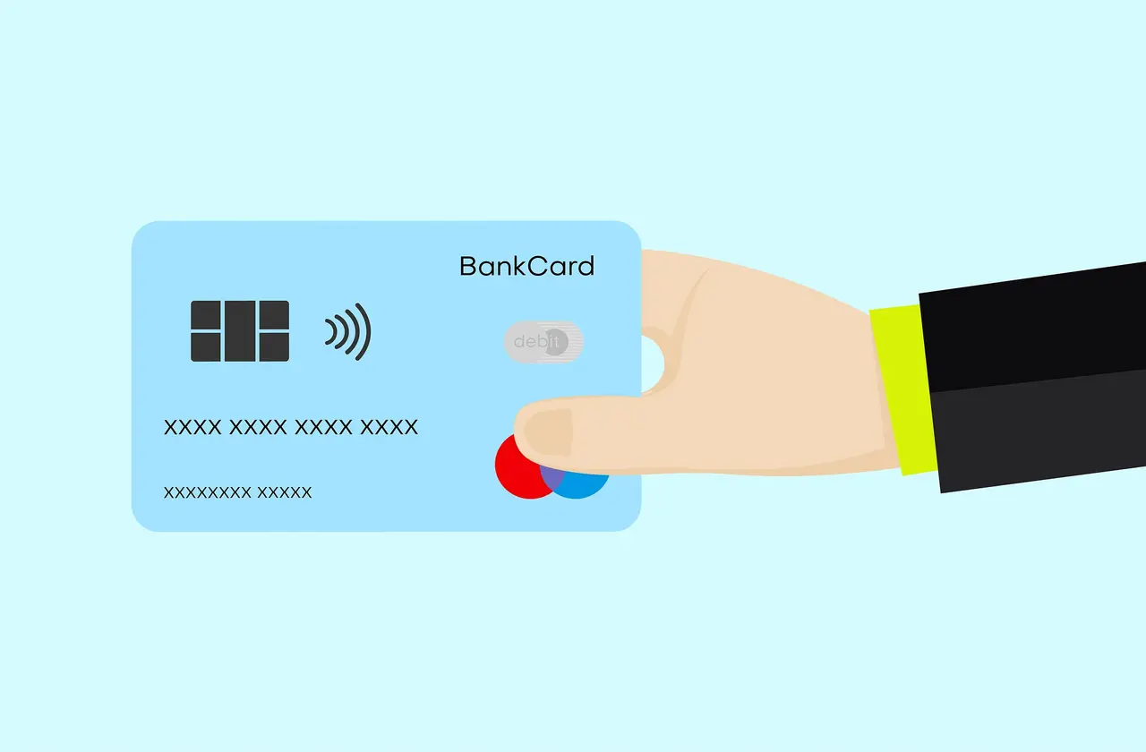A credit card resting on a dark surface, representing crypto credit cards