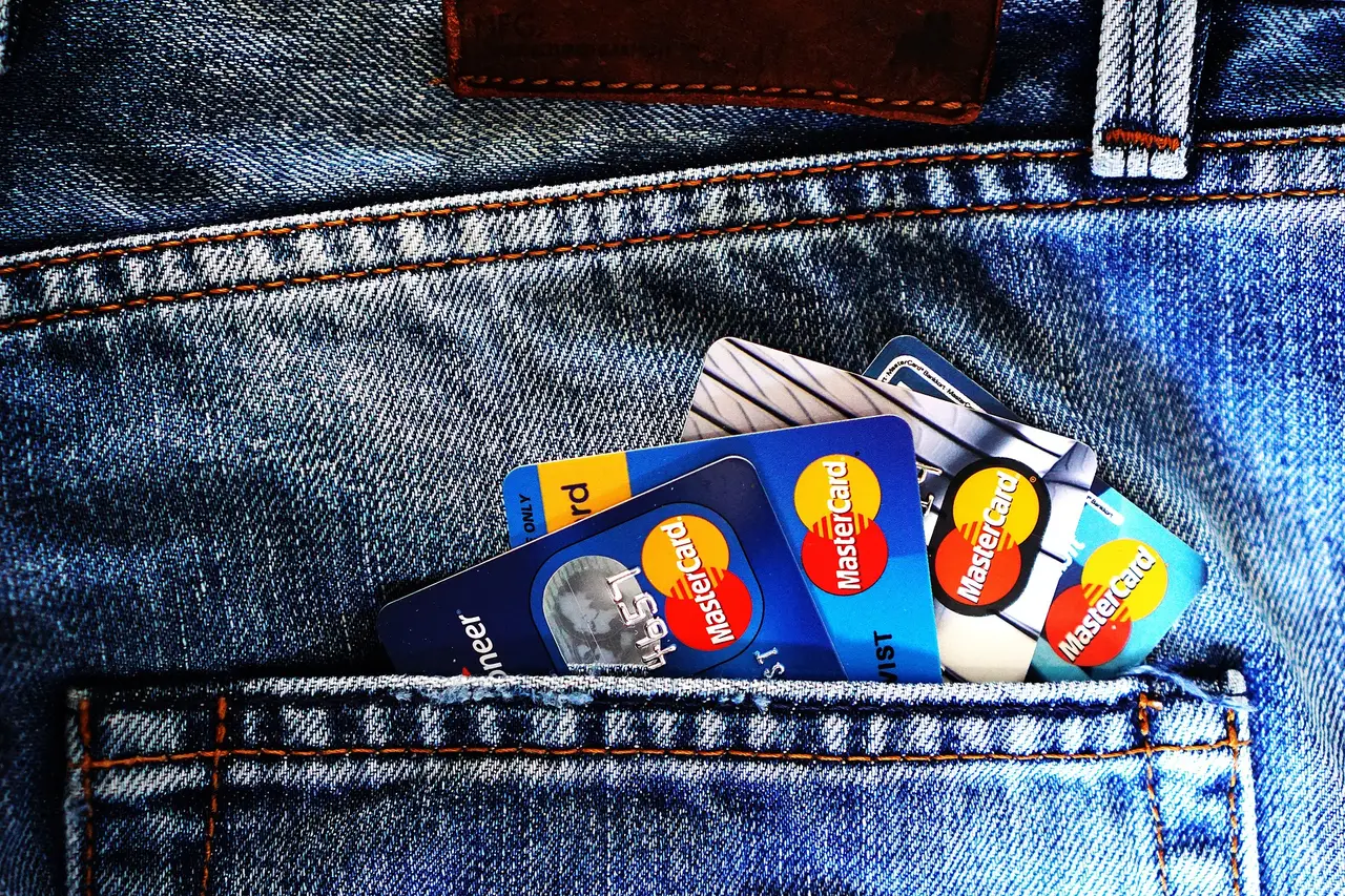 Physical payment cards in hand, representing crypto card delivery and design tiers